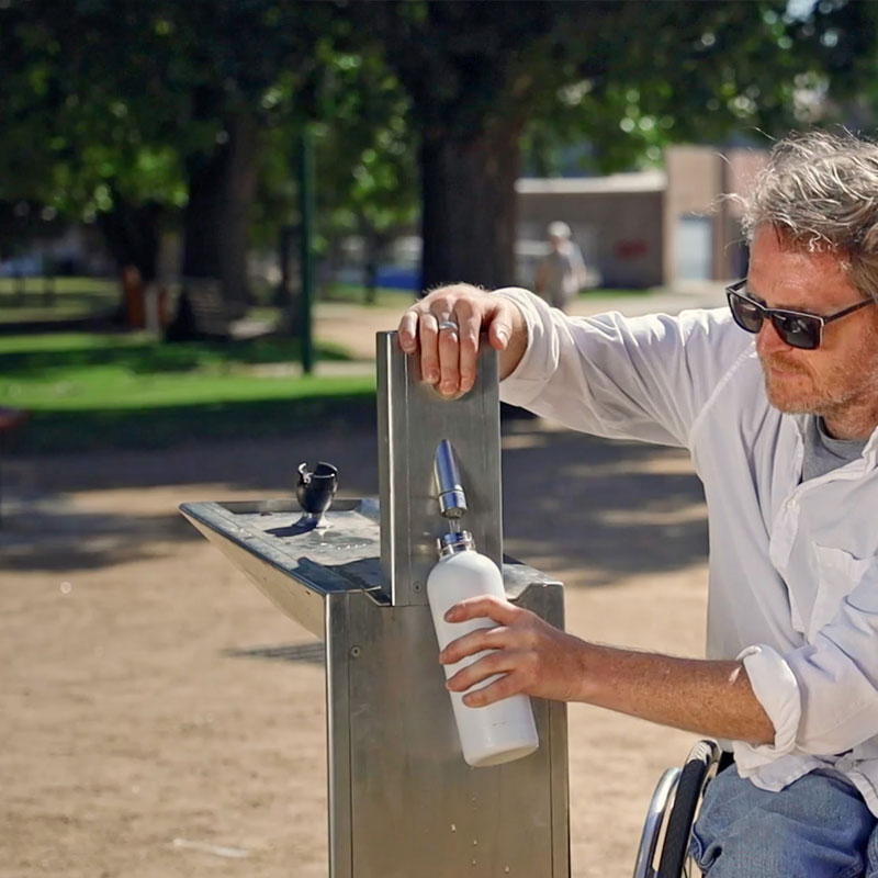 Ryan using a lowered drinking fountain